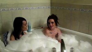  Two hot young brunettes engage in lesbian sex in the bathtub